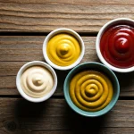 Gatorade Zero Pros And Cons: Culinary Guide & Nutrition | FoodieCX 2 Various colorful burger condiments including ketchup, mustard, and aioli in small bowls. (AI Generated Image)