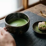 Tooyoojoo in Culinary Culture — Aesthetics, History & Meanings 2 Traditional japanese handcrafted ceramic tea bowl with matcha and seasonal wagashi (AI Generated Image)